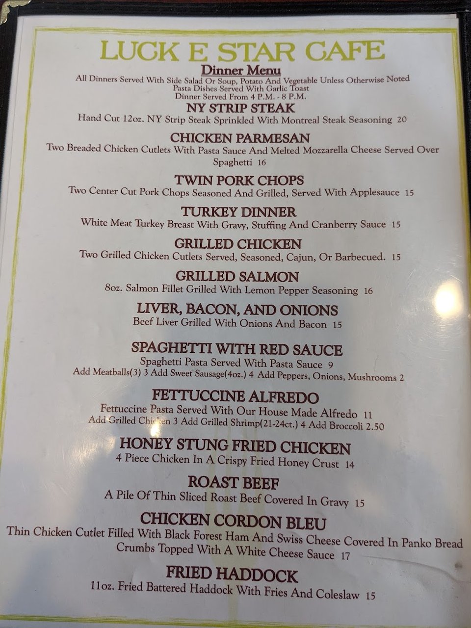 Diner menu beside a cup of coffee.